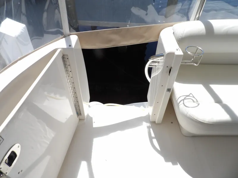 Slide: The Image of 2003 Sea Ray 390 Motor Yacht interior seating area with cup holders. - 16