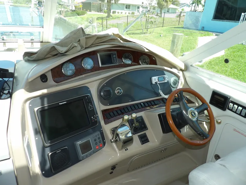 Slide: The Image of 2003 Sea Ray 390 Motor Yacht helm with navigation instruments and wooden steering wheel. - 20