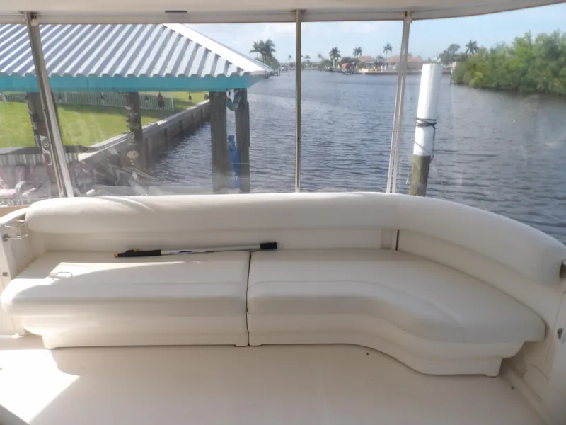 Slide: The Image of 2003 Sea Ray 390 Motor Yacht interior with white seating and waterfront view. - 27