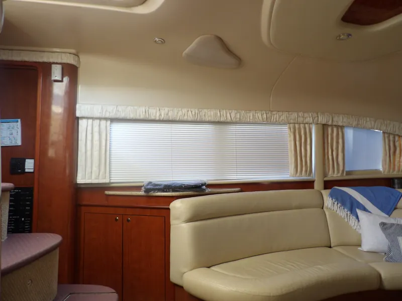 Slide: The Image of Interior of 2003 Sea Ray 390 Motor Yacht with beige leather seating and wooden cabinetry. - 44