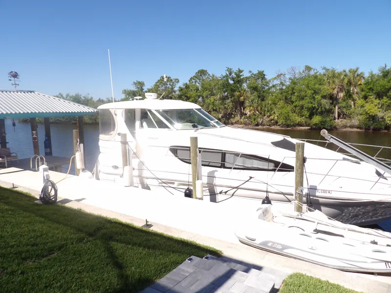 Slide: The Image of 2003 Sea Ray 390 Motor Yacht docked by a riverside. - 5