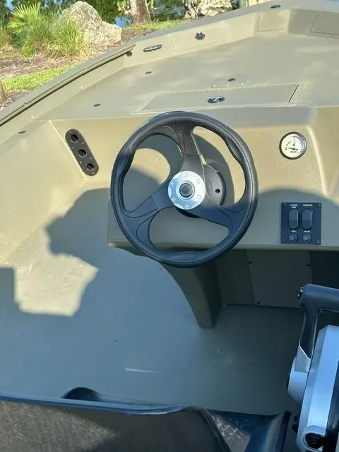 Slide: The Image of 2024 Tracker Grizzly 1754 SC boat steering console with controls and gauge. - 4