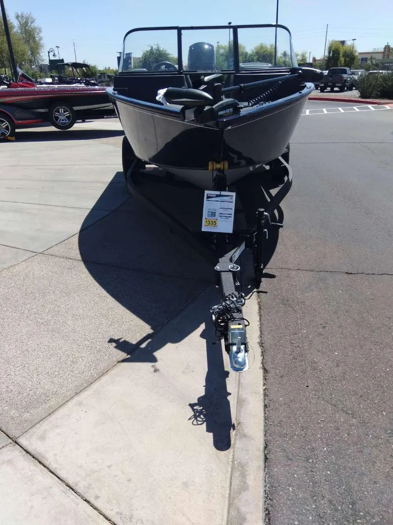 Slide: The Image of 2024 Tracker Pro Guide V-175 WT boat on trailer in parking lot. - 2
