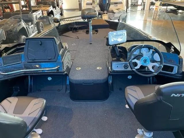 Slide: The Image of 2024 Nitro ZV21 boat interior with steering wheel, seats, and Lowrance electronics. - 2