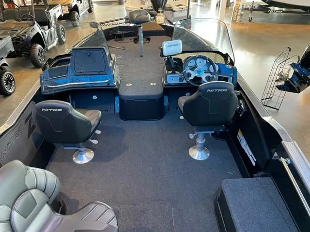 Slide: The Image of 2024 Nitro ZV21 fishing boat interior with steering console, seating, and storage compartments. - 3