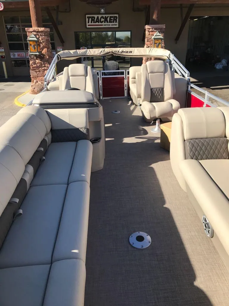 Slide: The Image of 2024 Sun Tracker Party Barge 24 DLX interior with plush seating and spacious layout. - 11