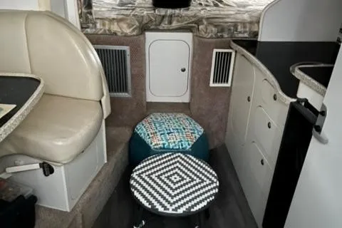 Slide: The Image of Interior of 2000 Rinker 310 Fiesta Vee boat with seating and storage. - 12