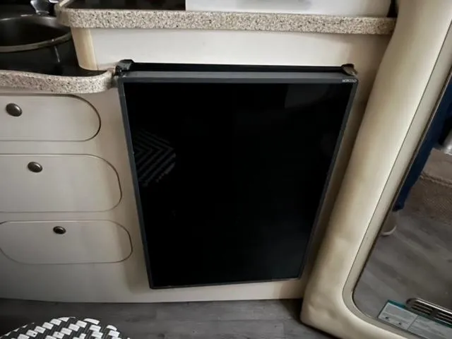 Slide: The Image of Compact kitchen area in a 2000 Rinker 310 Fiesta Vee boat. - 20