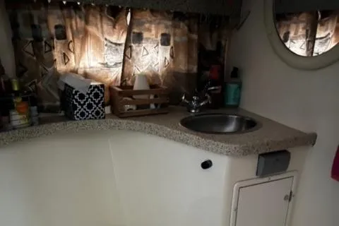Slide: The Image of 2000 Rinker 310 Fiesta Vee boat interior with sink and countertop. - 23