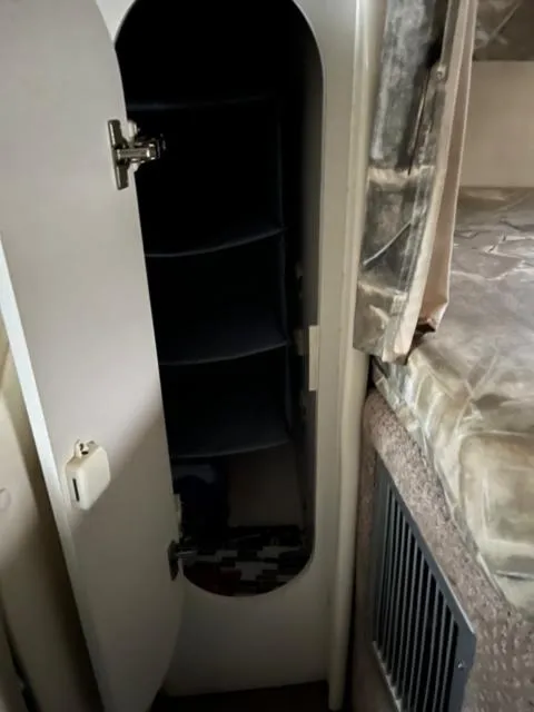 Slide: The Image of 2000 Rinker 310 Fiesta Vee cabin storage and sleeping area. - 24