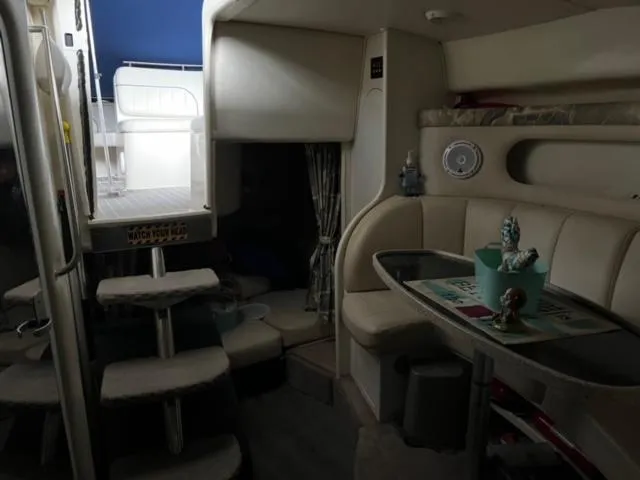 Slide: The Image of Interior of a 2000 Rinker 310 Fiesta Vee boat with seating and steps to deck. - 25