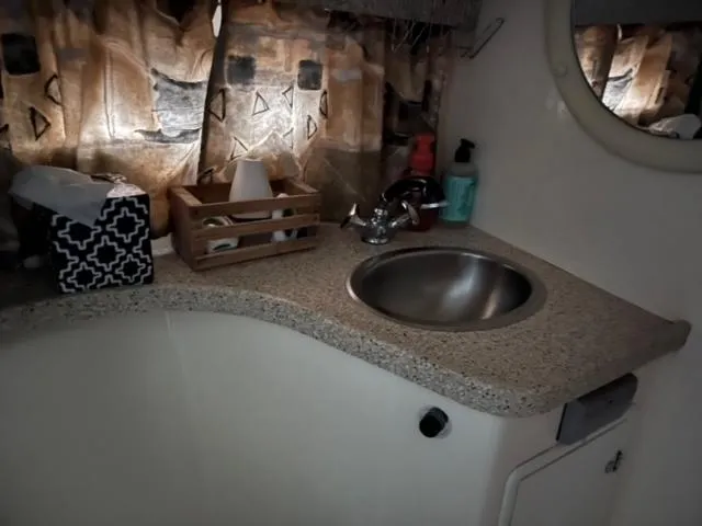 Slide: The Image of Compact bathroom sink area in a 2000 Rinker 310 Fiesta Vee boat. - 26