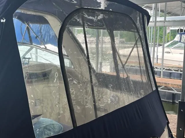 Slide: The Image of 2000 Rinker 310 Fiesta Vee boat with enclosed cockpit at marina. - 3