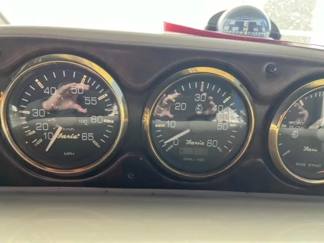 Slide: The Image of Dashboard gauges of a 2000 Rinker 310 Fiesta Vee boat. - 30