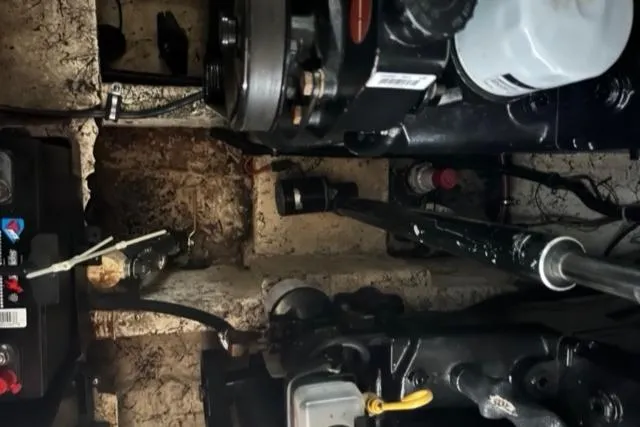 Slide: The Image of Engine compartment of a 2000 Rinker 310 Fiesta Vee boat, showing mechanical components. - 33