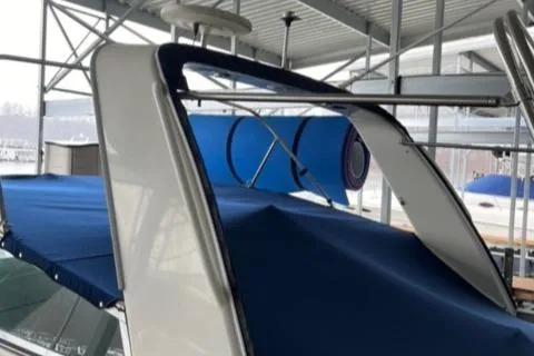 Slide: The Image of 2000 Rinker 310 Fiesta Vee boat with blue canopy in marina. - 5