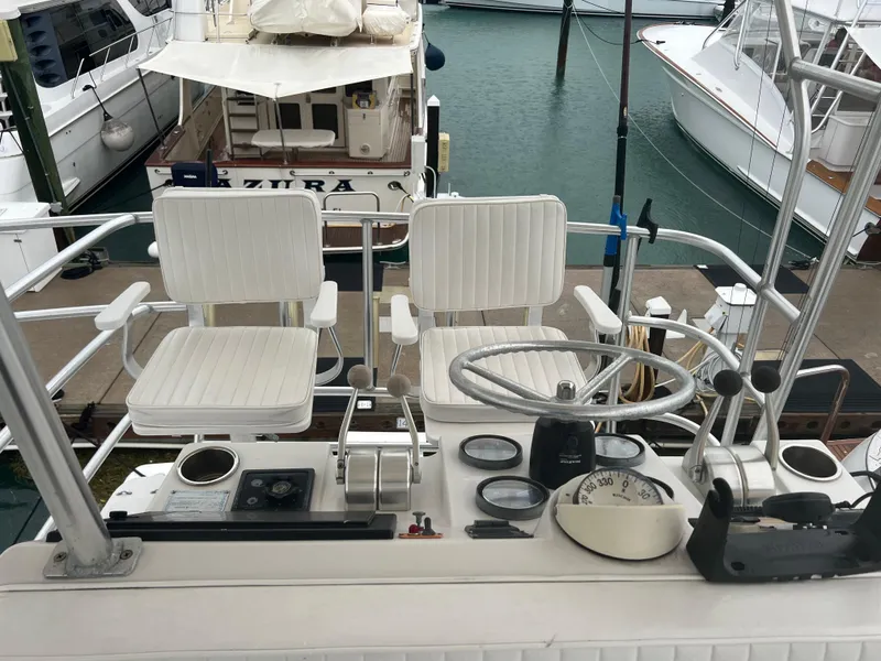 Slide: The Image of 2001 Luhrs 34 Convertible boat helm with dual seats and navigation controls. - 10
