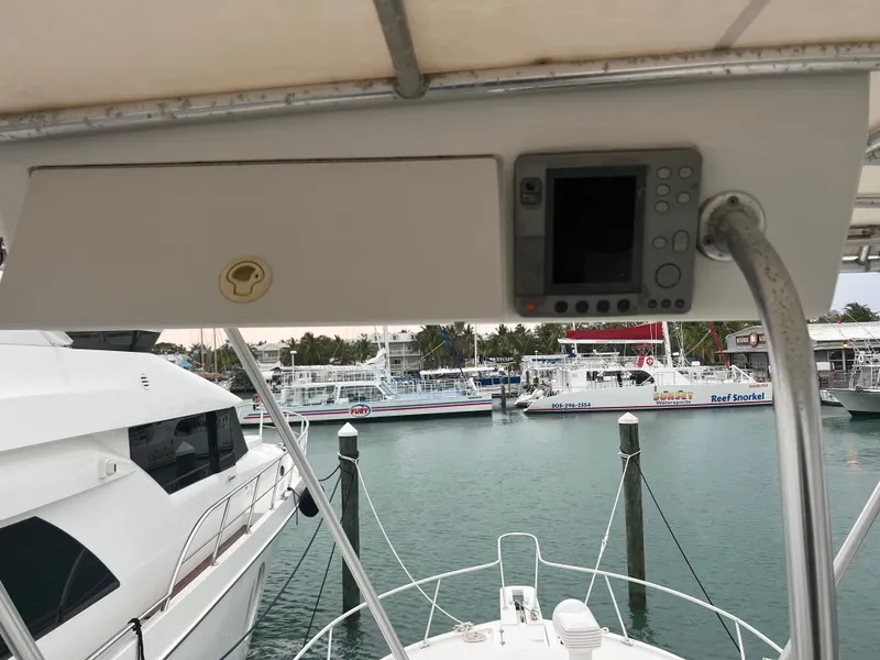Slide: The Image of 2001 Luhrs 34 Convertible yacht with navigation equipment, docked at a marina. - 12