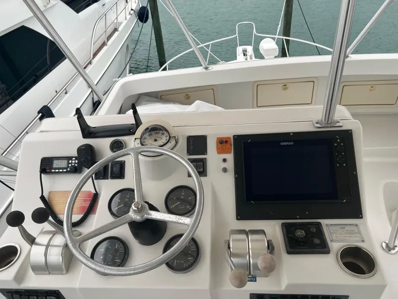Slide: The Image of 2001 Luhrs 34 Convertible helm station with steering wheel and navigation equipment. - 13