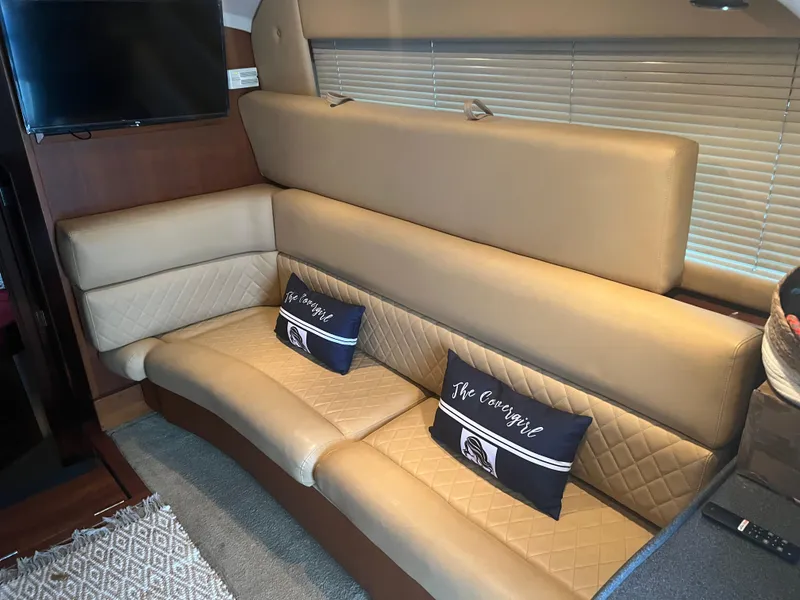 Slide: The Image of Luxurious interior of 2001 Luhrs 34 Convertible yacht with beige leather seating. - 16