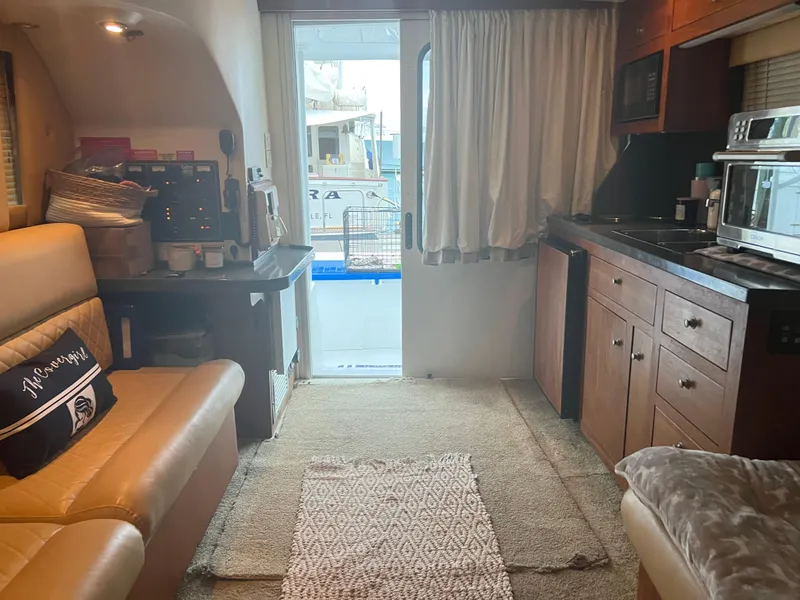 Slide: The Image of Interior of 2001 Luhrs 34 Convertible yacht with kitchenette and seating area. - 19