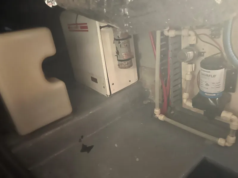 Slide: The Image of Engine room of a 2001 Luhrs 34 Convertible boat with equipment and wiring. - 27