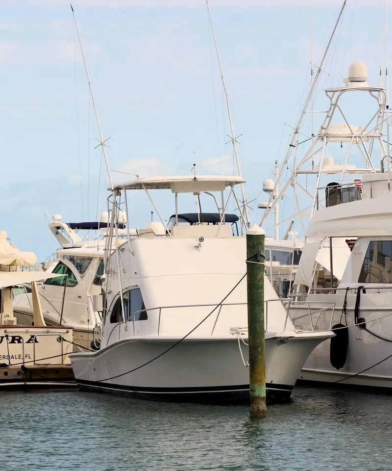 Slide: The Image of 2001 Luhrs 34 Convertible boat docked at a marina. - 3