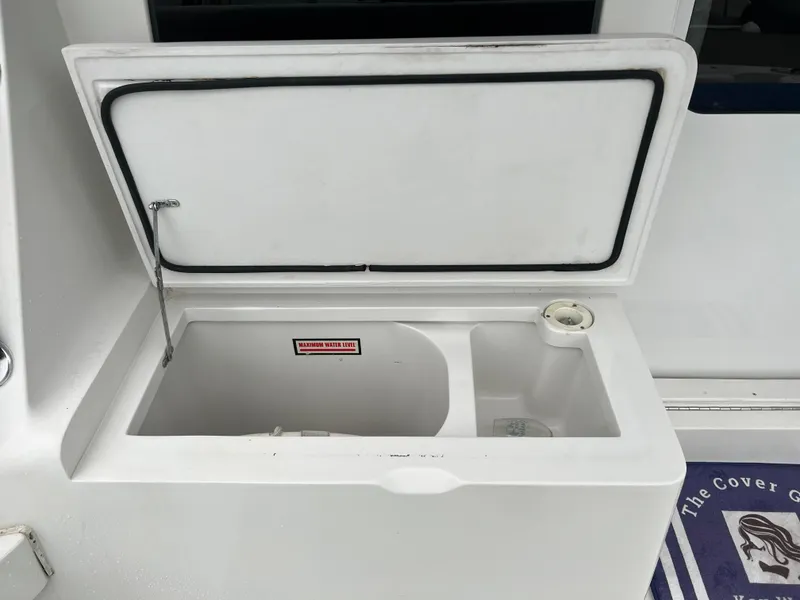 Slide: The Image of Open storage compartment on a 2001 Luhrs 34 Convertible boat. - 6