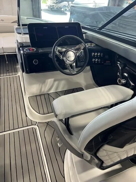 Slide: The Image of 2024 Sea Ray SLX 260 boat cockpit with modern steering wheel and control panel. - 5