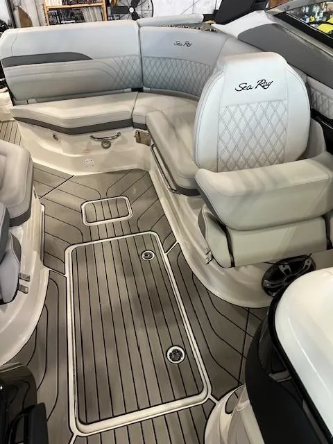 Slide: The Image of 2024 Sea Ray SLX 260 boat interior with luxurious seating and teak flooring. - 7