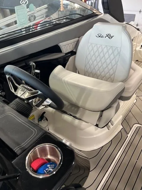 Slide: The Image of 2024 Sea Ray SLX 260 boat interior with luxurious captain's chair and modern steering wheel. - 8