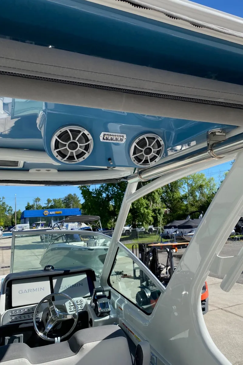 Slide: The Image of 2024 Finseeker 280 DC boat interior with Garmin navigation system and overhead speakers. - 10