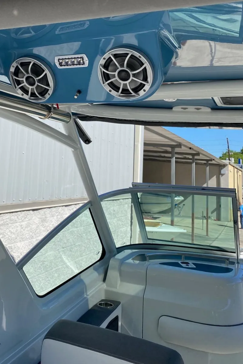 Slide: The Image of 2024 Finseeker 280 DC boat interior with speakers and seating. - 11