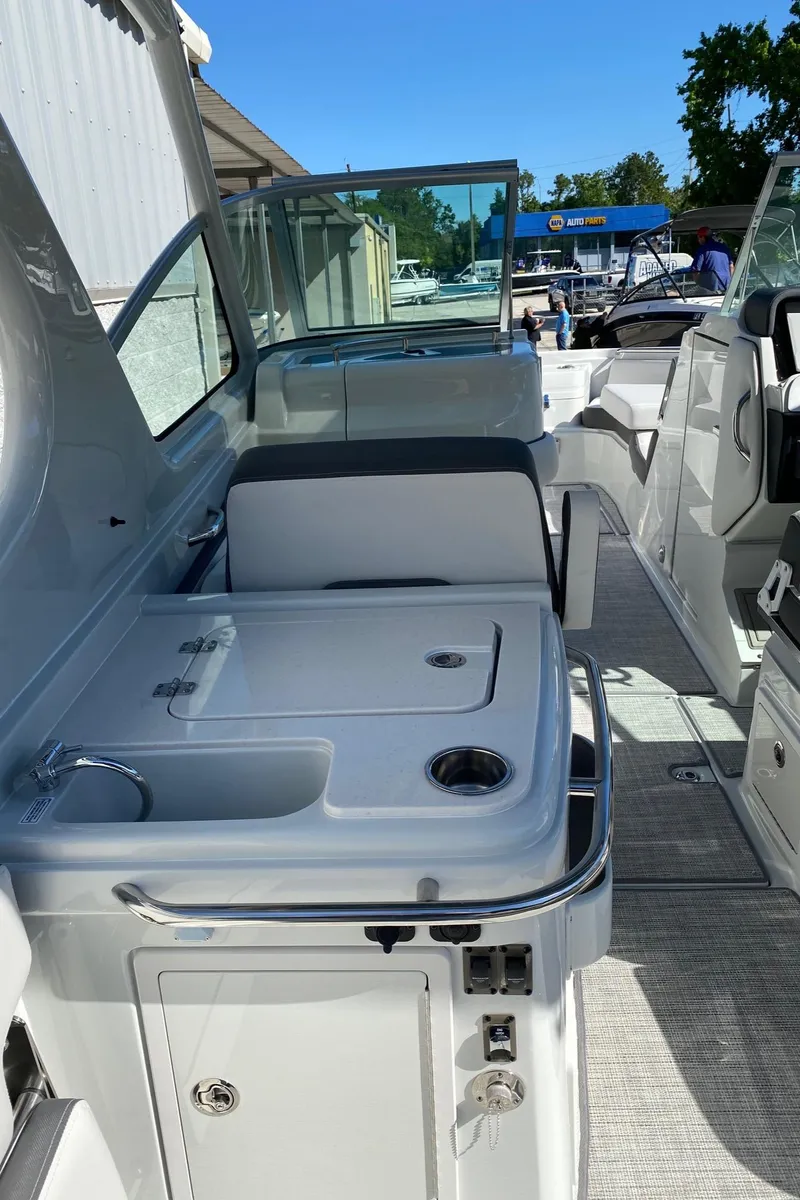 Slide: The Image of 2024 Finseeker 280 DC boat interior with seating and sink. - 17