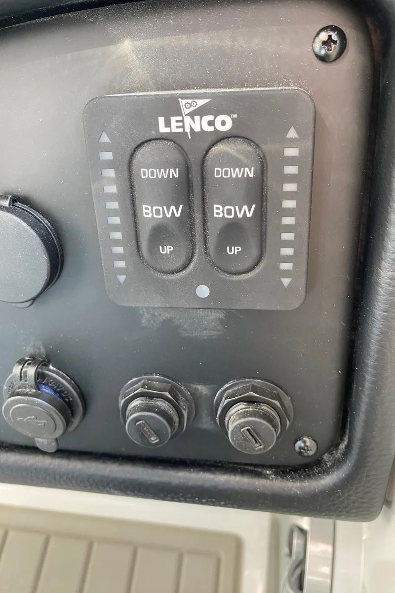 Slide: The Image of Control panel of a 2024 Finseeker 280 DC boat with Lenco trim tab switches. - 20