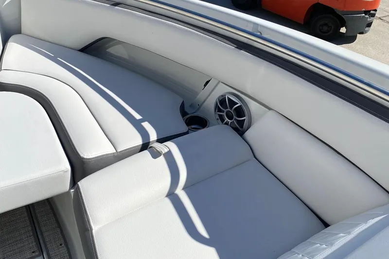 Slide: The Image of 2024 Finseeker 280 DC boat interior with white cushioned seating and speaker. - 23