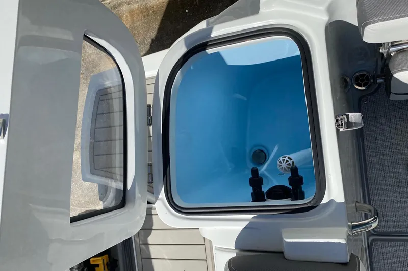 Slide: The Image of 2024 Finseeker 280 DC livewell with open lid. - 29