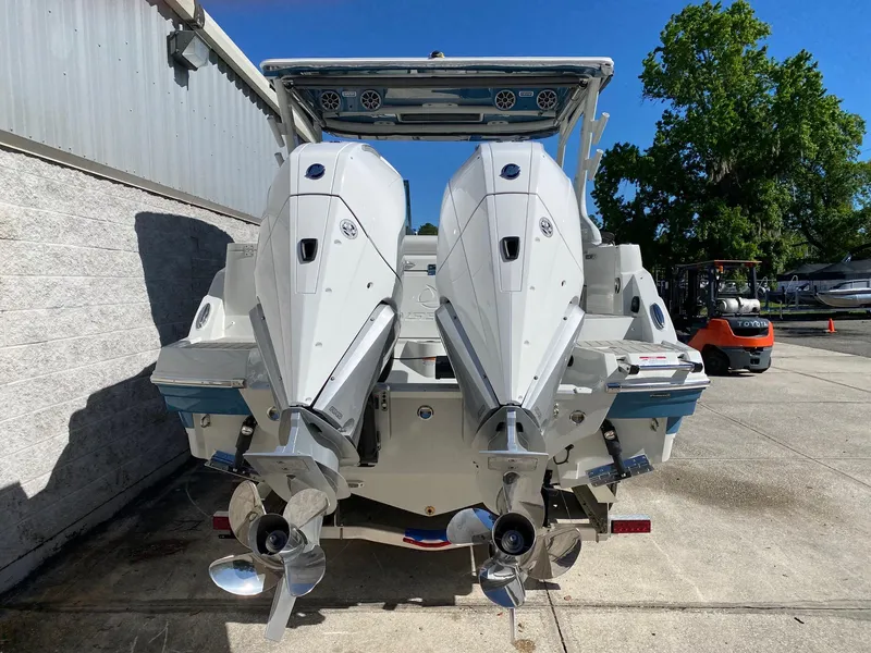 Slide: The Image of 2024 Finseeker 280 DC boat with dual outboard engines, rear view. - 3