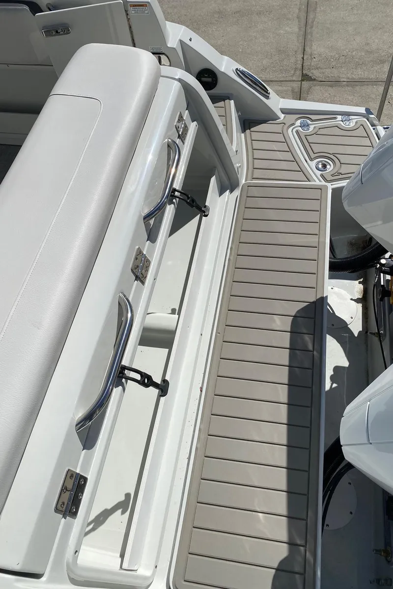 Slide: The Image of 2024 Finseeker 280 DC boat deck with seating and storage compartments. - 32