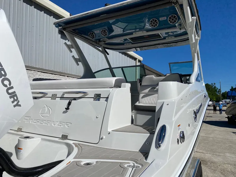 Slide: The Image of 2024 Finseeker 280 DC boat, rear view, docked, showcasing seating and storage. - 4