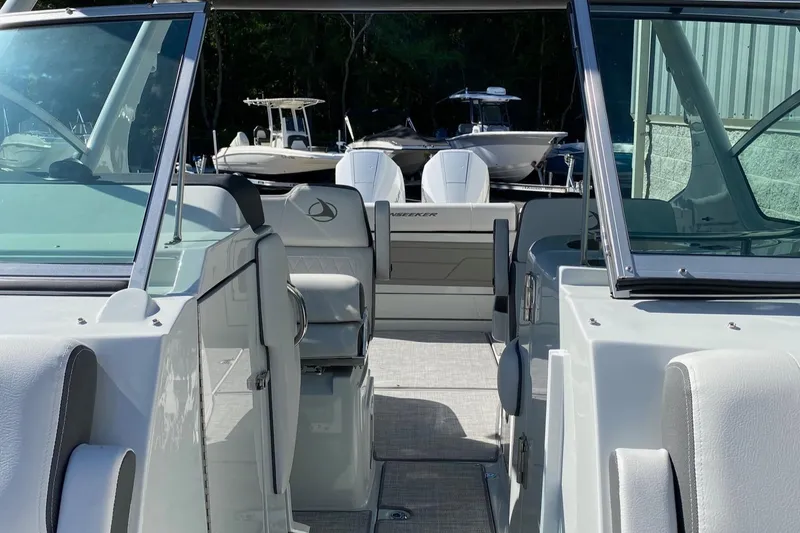Slide: The Image of 2024 Finseeker 280 DC boat interior with seating and open deck. - 7