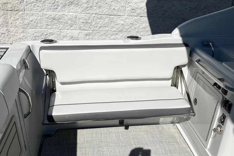 Slide: The Image of 2024 Finseeker 280 DC boat interior with white cushioned seating. - 9