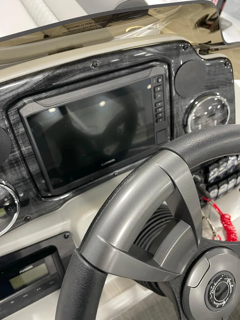 Slide: The Image of 2024 Avalon Venture 85 Rear Fish boat dashboard with steering wheel and electronic display. - 15