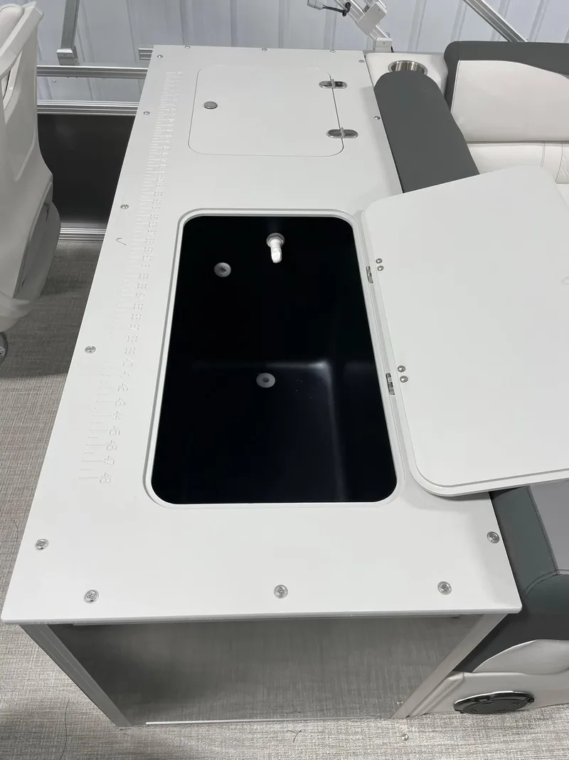 Slide: The Image of 2024 Avalon Venture 85 Rear Fish boat with open storage compartment. - 19