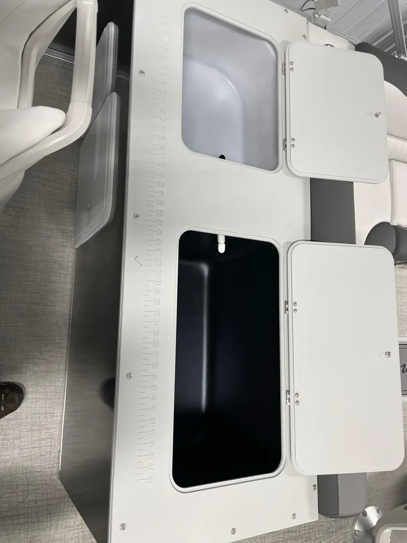 Slide: The Image of 2024 Avalon Venture 85 Rear Fish boat with open storage compartments. - 21