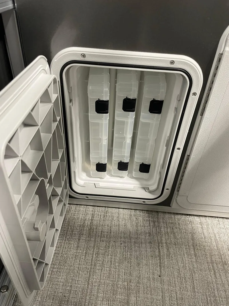 Slide: The Image of 2024 Avalon Venture 85 Rear Fish storage compartment with open hatch. - 22