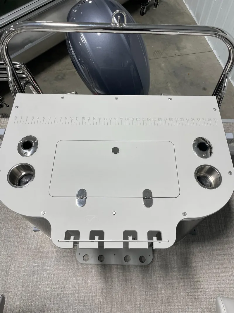 Slide: The Image of 2024 Avalon Venture 85 Rear Fish boat console with rod holders and storage compartments. - 23