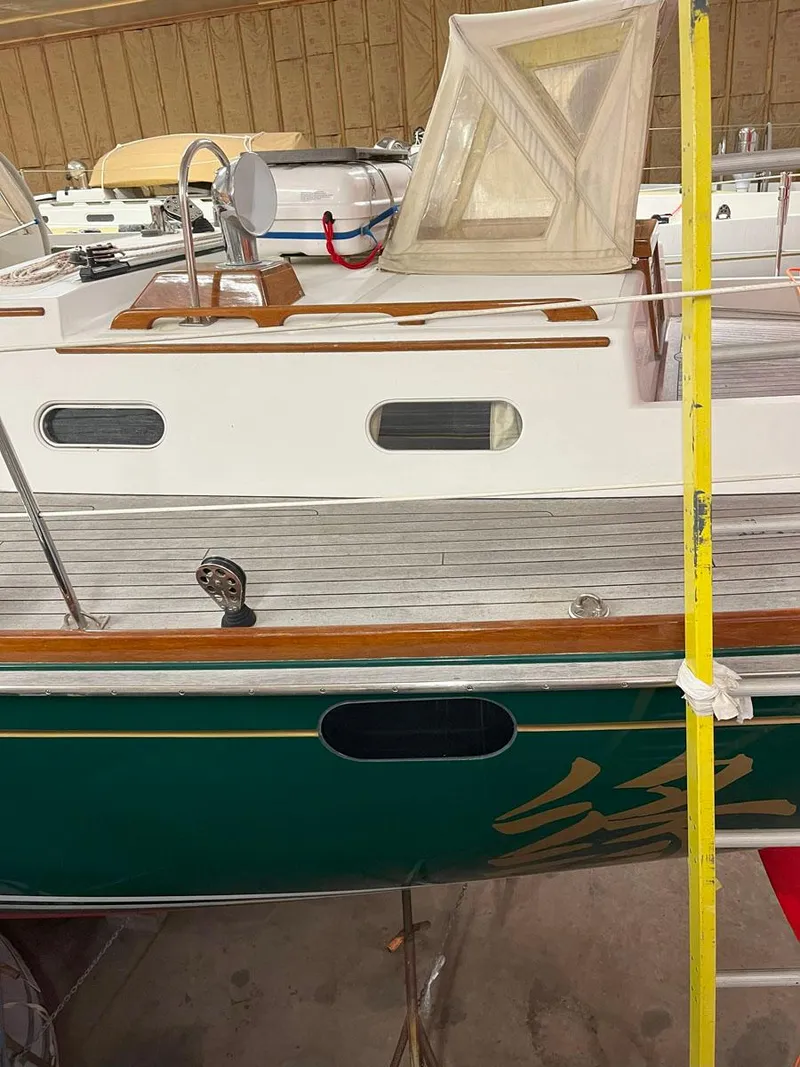 Slide: The Image of 2001 Hinckley Sou'wester 59 CC sailboat with green hull and wooden deck details. - 20