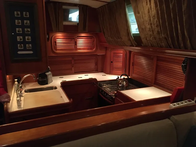 Slide: The Image of Interior of 2001 Hinckley Sou'wester 59 CC yacht kitchen with wooden cabinetry. - 29