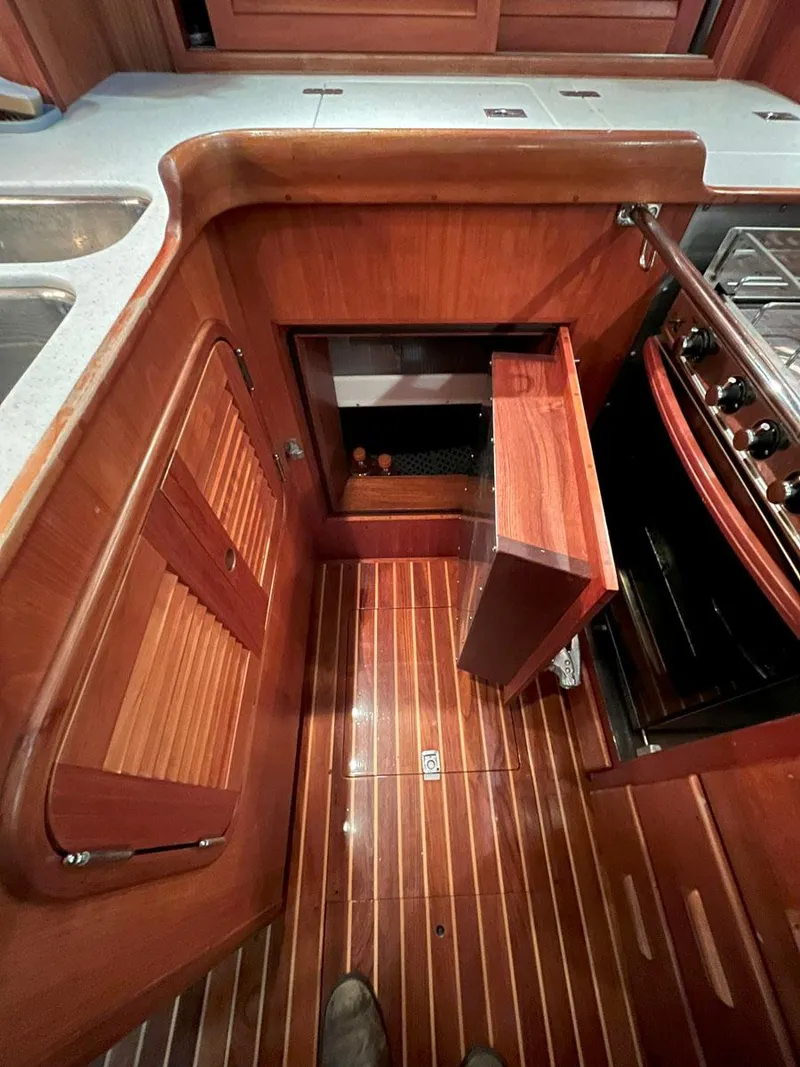 Slide: The Image of Hinckley Sou'wester 59 CC 2001 yacht kitchen with wooden cabinetry and flooring. - 30